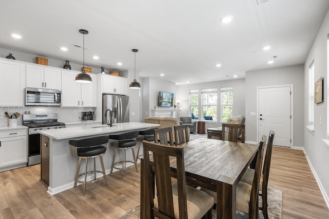 3011 Rum River Way, Anoka, MN 55303 - dining space with recessed lighting, light wood-type flooring, and baseboards
