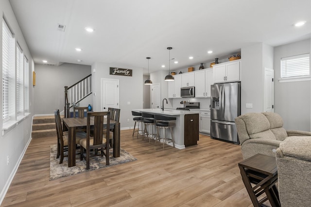 3011 Rum River Way, Anoka, MN 55303 - dining room featuring stairway, light wood-style floors, recessed lighting, and baseboards