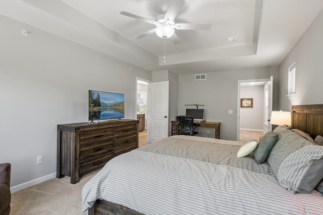 3011 Rum River Way, Anoka, MN 55303 - bedroom featuring a tray ceiling, light carpet, baseboards, and multiple windows