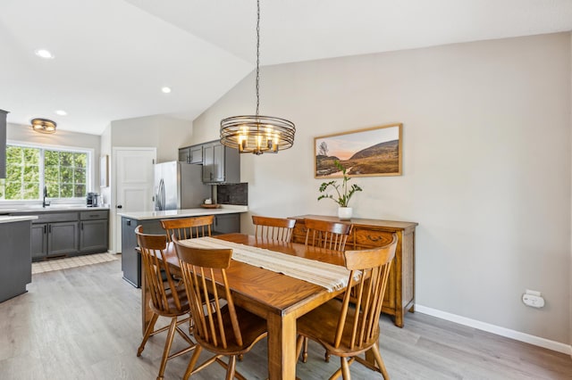 805 Natalie Dr, Buffalo, MN 55313 - dining room featuring light wood finished floors, a chandelier, lofted ceiling, baseboards, and recessed lighting