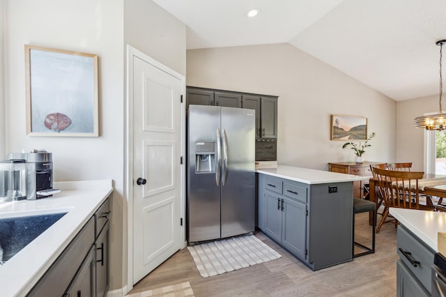 805 Natalie Dr, Buffalo, MN 55313 - kitchen with stainless steel fridge with ice dispenser, vaulted ceiling, light wood-type flooring, a chandelier, and light countertops