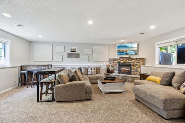 805 Natalie Dr, Buffalo, MN 55313 - carpeted living area with recessed lighting, plenty of natural light, a textured ceiling, baseboards, and a fireplace