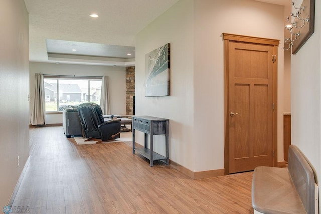 1908 65th Ave S, Fargo, ND 58104 - hall with light wood-style floors, baseboards, recessed lighting, and a tray ceiling