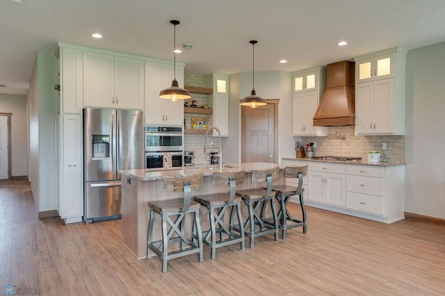 1908 65th Ave S, Fargo, ND 58104 - kitchen featuring appliances with stainless steel finishes, premium range hood, backsplash, light wood-style flooring, and recessed lighting
