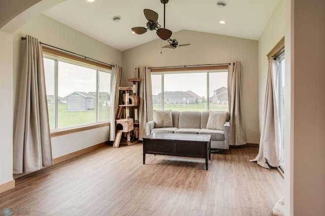 1908 65th Ave S, Fargo, ND 58104 - living area with ceiling fan, light wood-style flooring, arched walkways, vaulted ceiling, and baseboards