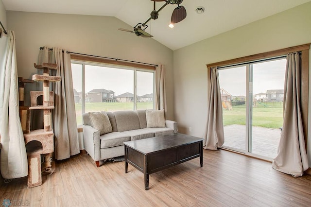 1908 65th Ave S, Fargo, ND 58104 - living room with vaulted ceiling and light wood-style floors