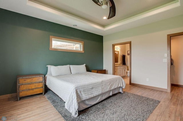 1908 65th Ave S, Fargo, ND 58104 - bedroom with a tray ceiling, light wood-style floors, baseboards, connected bathroom, and recessed lighting