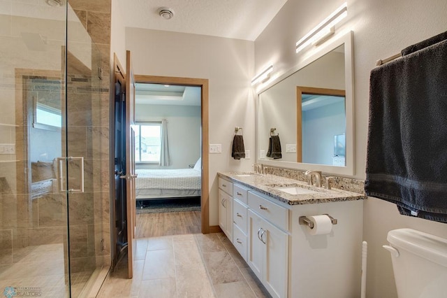 1908 65th Ave S, Fargo, ND 58104 - ensuite bathroom featuring double vanity, a shower stall, and toilet