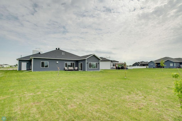 1908 65th Ave S, Fargo, ND 58104 - rear view of house with a lawn