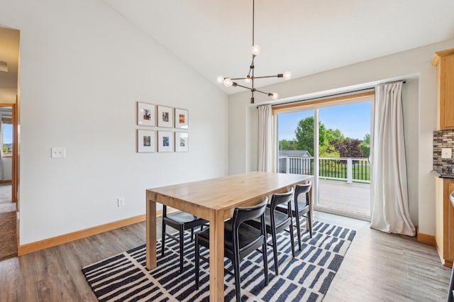 30259 Fox Run Rd, Stacy, MN 55079 - dining space featuring light wood-style floors, a chandelier, baseboards, and high vaulted ceiling
