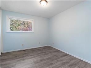 4819 Grenwich Way N, Oakdale, MN 55128 - empty room featuring wood finished floors and baseboards