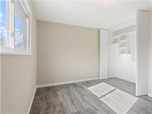 4819 Grenwich Way N, Oakdale, MN 55128 - unfurnished room featuring baseboards and wood finished floors