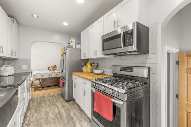469 Little Canada Rd E, Little Canada, MN 55117 - kitchen with stainless steel appliances, light wood finished floors, white cabinets, recessed lighting, and decorative backsplash
