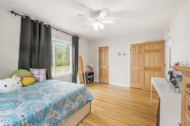 469 Little Canada Rd E, Little Canada, MN 55117 - bedroom with light wood finished floors, ceiling fan, and baseboards