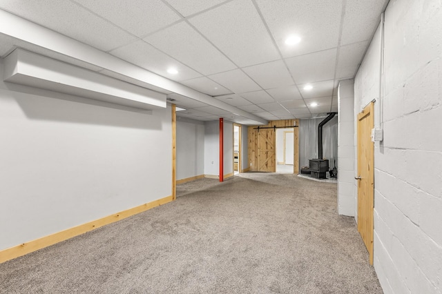 469 Little Canada Rd E, Little Canada, MN 55117 - finished below grade area featuring carpet flooring, a wood stove, recessed lighting, a paneled ceiling, and concrete block wall