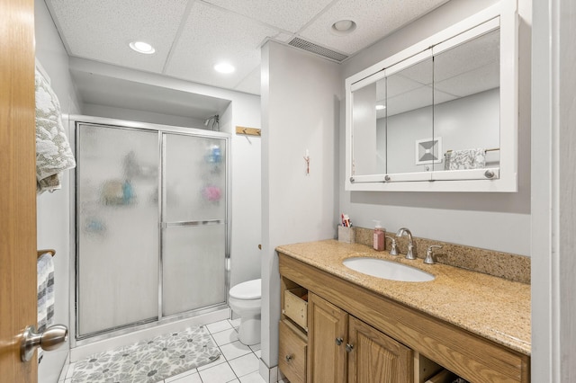 469 Little Canada Rd E, Little Canada, MN 55117 - bathroom with toilet, vanity, a shower stall, tile patterned flooring, and a paneled ceiling