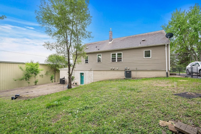 469 Little Canada Rd E, Little Canada, MN 55117 - rear view of property with a chimney and central air condition unit