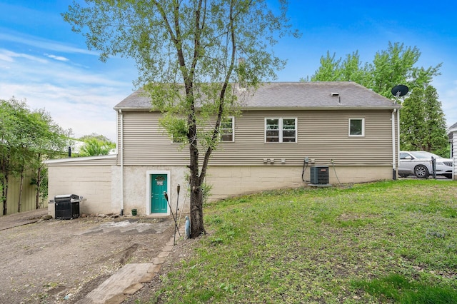 469 Little Canada Rd E, Little Canada, MN 55117 - back of house featuring cooling unit, a lawn, and roof with shingles
