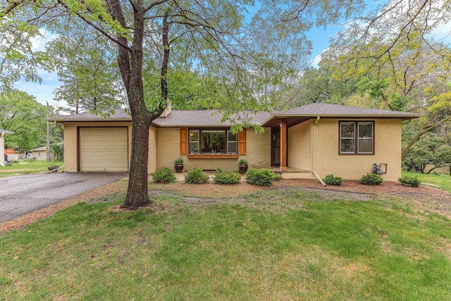 5725 Golden Valley Rd, Golden Valley, MN 55422 - ranch-style home featuring an attached garage, asphalt driveway, a front lawn, and stucco siding