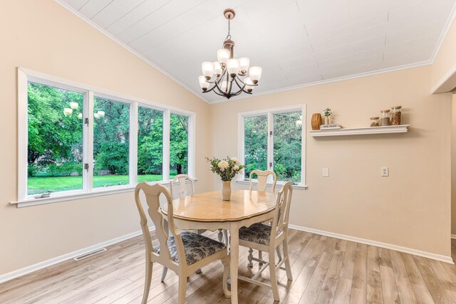 5725 Golden Valley Rd, Golden Valley, MN 55422 - dining space with ornamental molding, light wood finished floors, a chandelier, baseboards, and vaulted ceiling