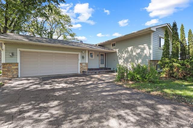720 Tanglewood Dr, Shoreview, MN 55126 - view of front of property featuring asphalt driveway and an attached garage