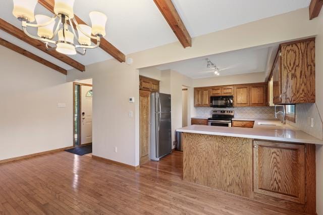 720 Tanglewood Dr, Shoreview, MN 55126 - kitchen with appliances with stainless steel finishes, a chandelier, a sink, brown cabinetry, and light countertops
