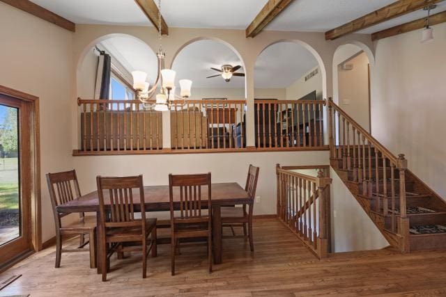 720 Tanglewood Dr, Shoreview, MN 55126 - dining area featuring a chandelier, wood finished floors, beamed ceiling, a ceiling fan, and baseboards