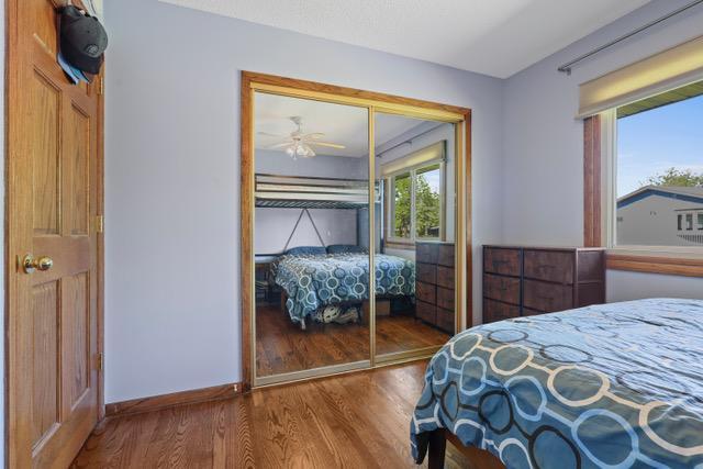 720 Tanglewood Dr, Shoreview, MN 55126 - bedroom with wood finished floors, a closet, and baseboards