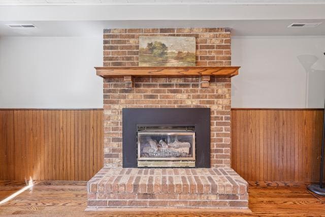 720 Tanglewood Dr, Shoreview, MN 55126 - detailed view of wood finished floors, wainscoting, wood walls, and a fireplace