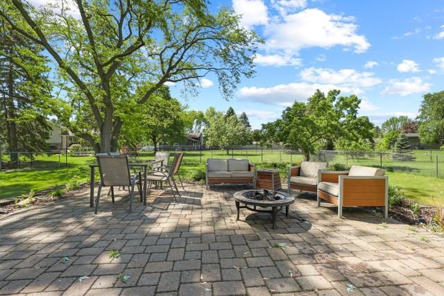 720 Tanglewood Dr, Shoreview, MN 55126 - fenced backyard with a patio area, an outdoor living space with a fire pit, and outdoor dining space