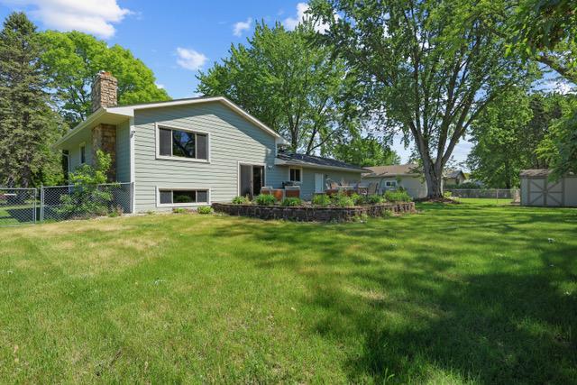 720 Tanglewood Dr, Shoreview, MN 55126 - rear view of property featuring a chimney