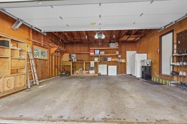 720 Tanglewood Dr, Shoreview, MN 55126 - garage with a garage door opener and freestanding refrigerator