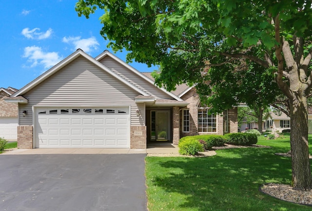 9149 Farnsworth Ave N, Brooklyn Park, MN 55443 - ranch-style home featuring brick siding, a front yard, asphalt driveway, and a garage