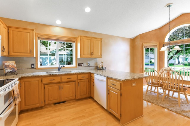 9149 Farnsworth Ave N, Brooklyn Park, MN 55443 - kitchen featuring white appliances, light wood-style flooring, a sink, a peninsula, and lofted ceiling