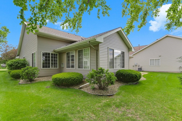9149 Farnsworth Ave N, Brooklyn Park, MN 55443 - view of property exterior featuring a lawn and central air condition unit