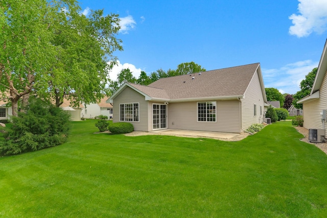 9149 Farnsworth Ave N, Brooklyn Park, MN 55443 - back of property with cooling unit, a patio area, a yard, and a shingled roof