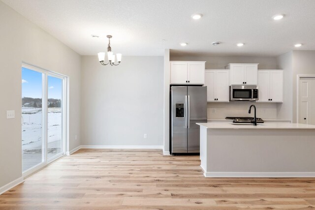 23225 Creekview Ct, Rogers, MN 55374 - kitchen featuring stainless steel appliances, white cabinetry, light countertops, light wood-type flooring, and recessed lighting