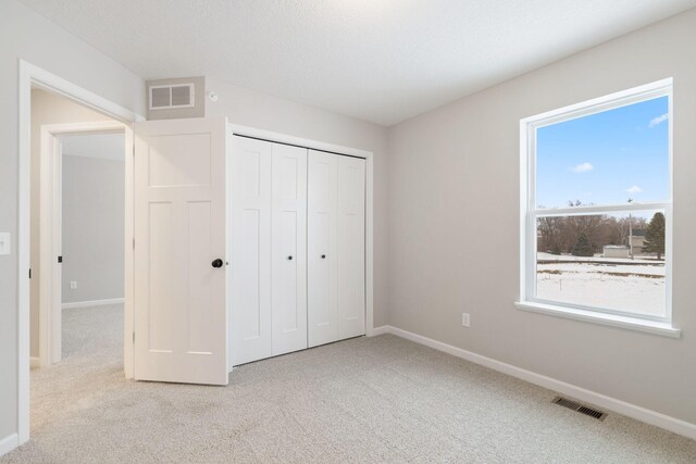 23225 Creekview Ct, Rogers, MN 55374 - unfurnished bedroom with light carpet and a closet