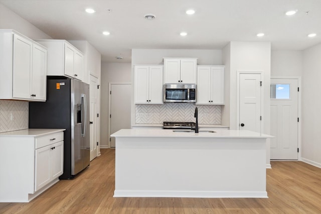 23229 Creekview Ct, Rogers, MN 55374 - kitchen with stainless steel appliances, a sink, decorative backsplash, white cabinetry, and recessed lighting