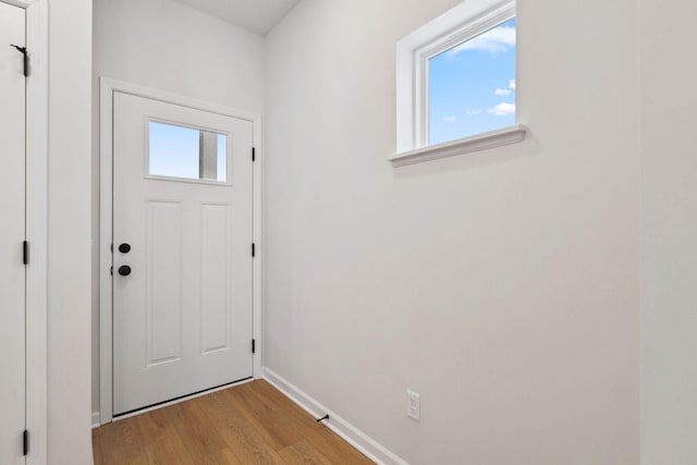 23229 Creekview Ct, Rogers, MN 55374 - doorway featuring light wood-style flooring and baseboards