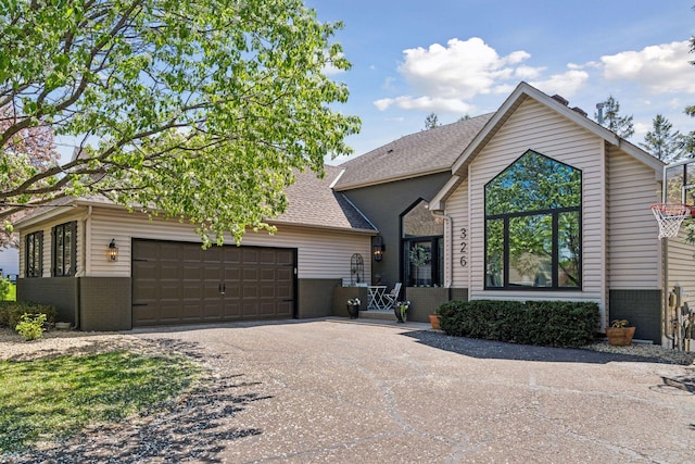 326 Lady Slipper Ln, Vadnais Heights, MN 55127 - view of front of home with brick siding, a garage, driveway, and roof with shingles