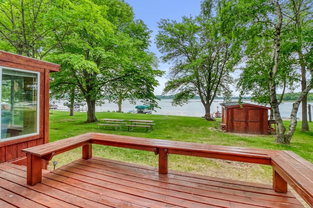 24505 Twilight Ln, Lida Twp, MN 56572 - wooden terrace with a storage unit, a water view, and a lawn