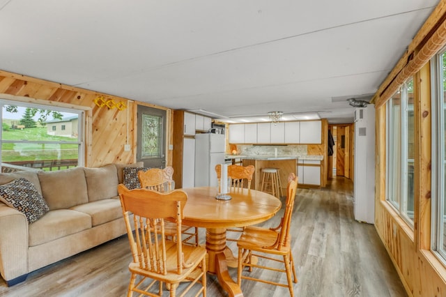 24505 Twilight Ln, Lida Twp, MN 56572 - dining area featuring light wood-type flooring and wood walls