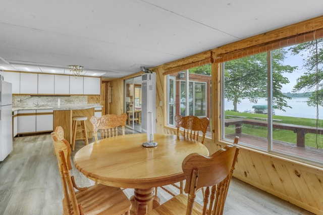 24505 Twilight Ln, Lida Twp, MN 56572 - dining room with light wood-type flooring and wooden walls