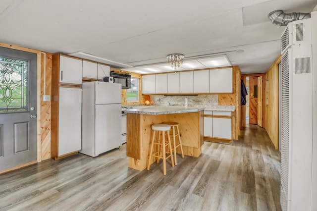 24505 Twilight Ln, Lida Twp, MN 56572 - kitchen with white appliances, a heating unit, light wood finished floors, and white cabinets