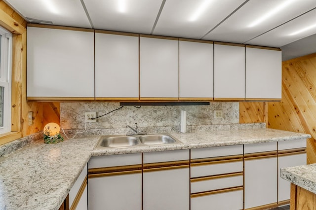 24505 Twilight Ln, Lida Twp, MN 56572 - kitchen with white cabinets, light countertops, decorative backsplash, and wood walls