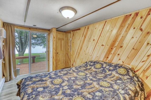 24505 Twilight Ln, Lida Twp, MN 56572 - bedroom featuring access to outside, wood walls, and wood finished floors