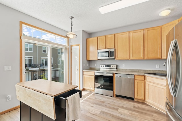 4107 Regent Ave N, Robbinsdale, MN 55422 - kitchen with appliances with stainless steel finishes, light brown cabinetry, light wood-type flooring, a textured ceiling, and light countertops