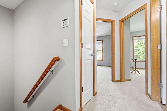 4107 Regent Ave N, Robbinsdale, MN 55422 - corridor featuring light colored carpet, a textured ceiling, an upstairs landing, and baseboards