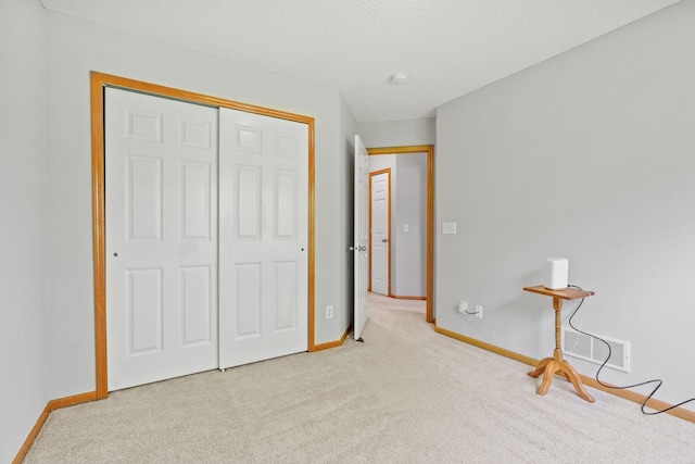 4107 Regent Ave N, Robbinsdale, MN 55422 - unfurnished bedroom featuring carpet floors, baseboards, a closet, and a textured ceiling